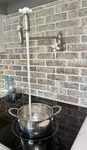 Kingston Brass Restoration Wall Mounted Pot Filler Dual Handle Brushed Nickel. Fixed Price $200.00.